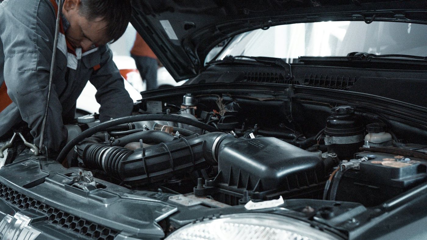 Mechanic inspecting an engine bay