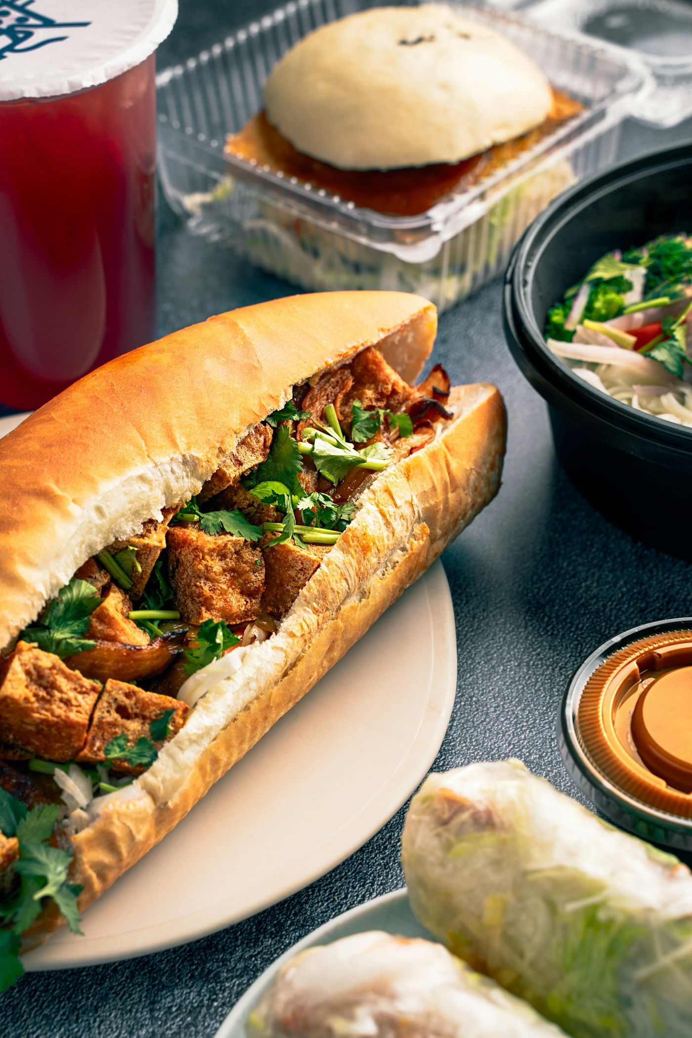 A bánh mì packed with grilled meat, herbs and pickles