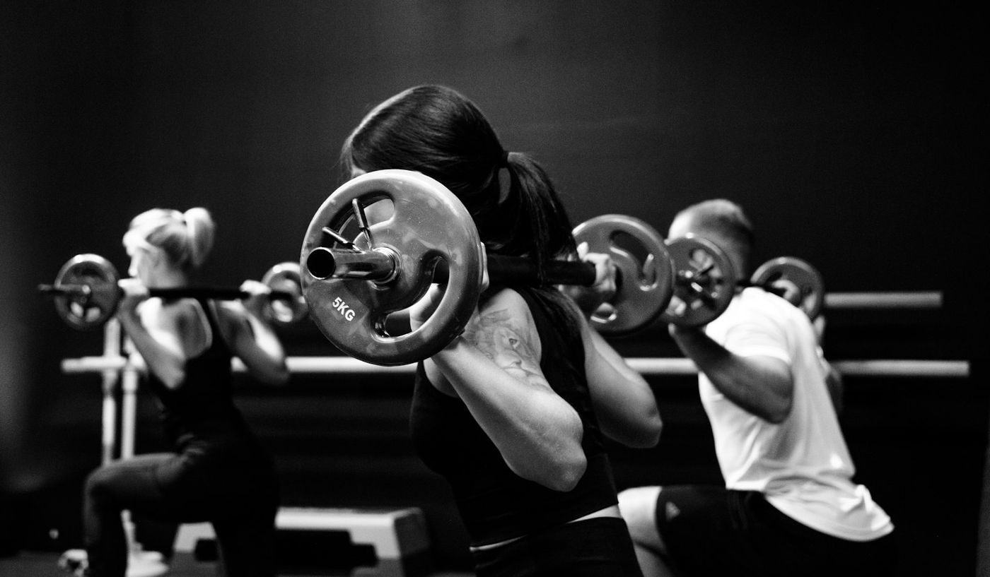 Small group lifting barbells together
