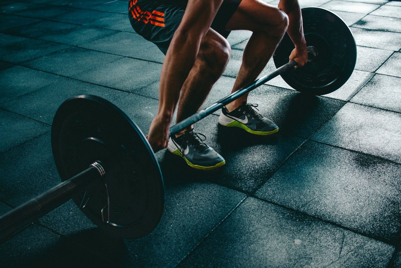Lifter gripping a loaded barbell