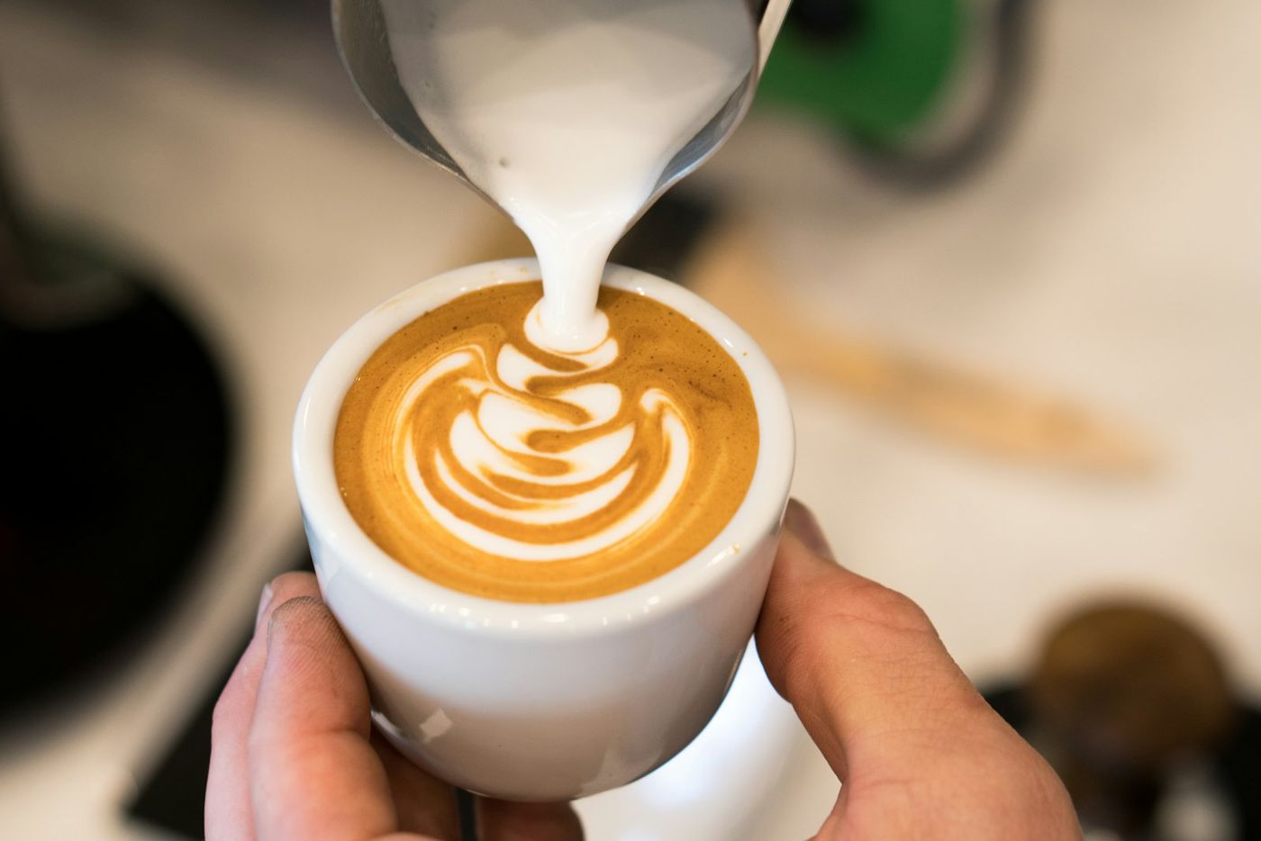 Milk being poured into a cappuccino