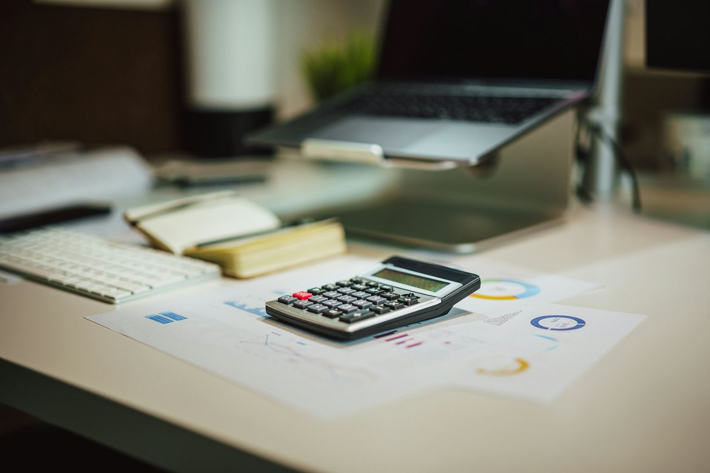 Calculator next to a laptop