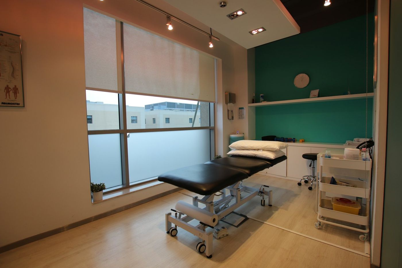 A treatment room with a table by the window