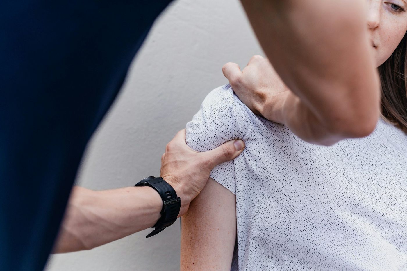 A physiotherapist working on a patient's shoulder